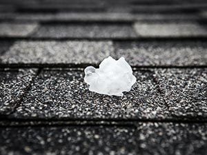 Hail-Damage-Roof-Missoula-MT-Montana-1 | Schrock Roofing Crumpled white tissue resting on rough asphalt roof shingles
