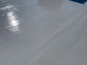 Smooth light-gray surface with bright sun reflections/glare